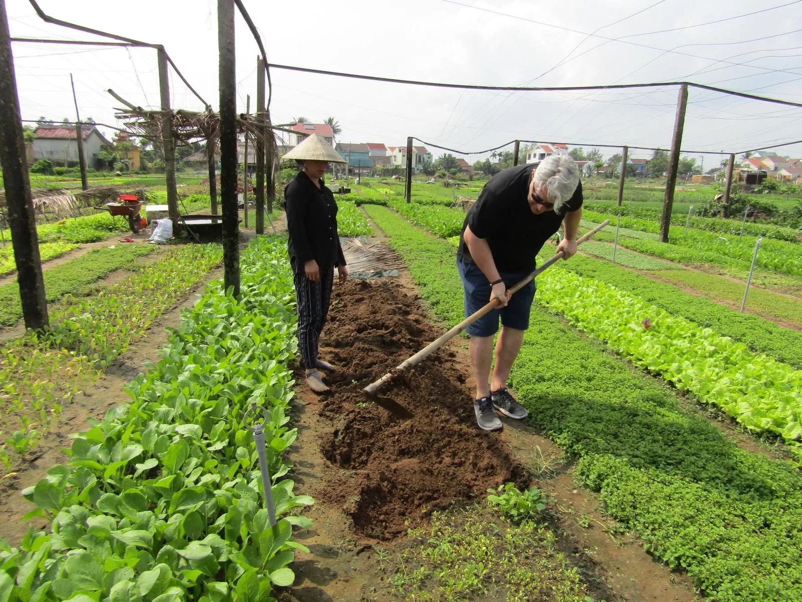 Couple visiting a riverside farm on a Hoi An countryside tour