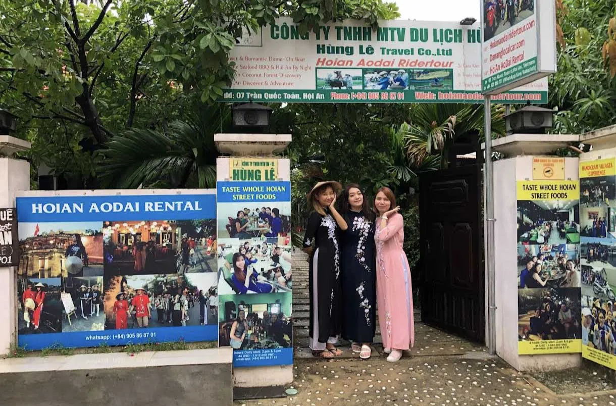 Friends posing in matching Ao Dai rentals