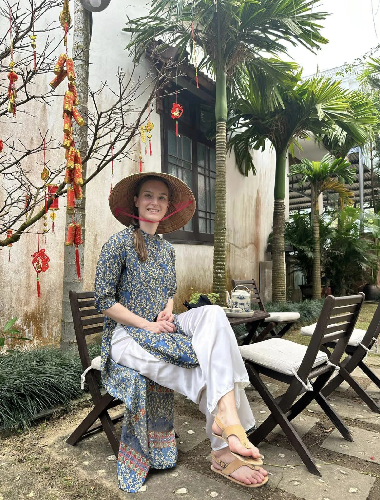 Woman in red Ao Dai posing in Hoi An