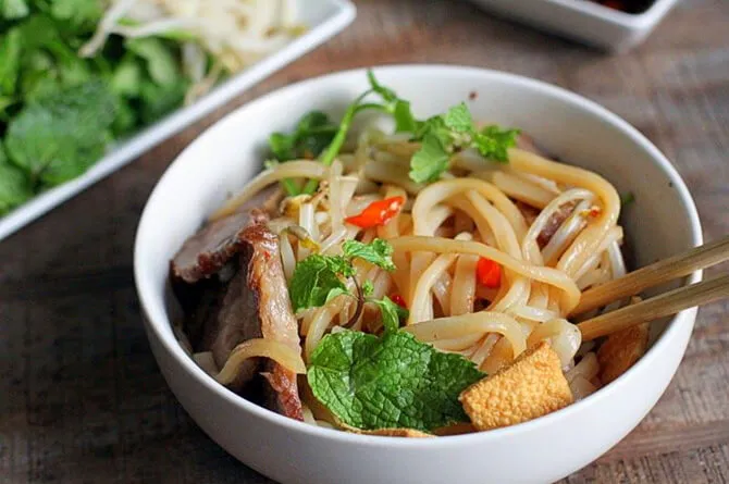 Cao Lau bowl prepared on a Hoi An food tour stop