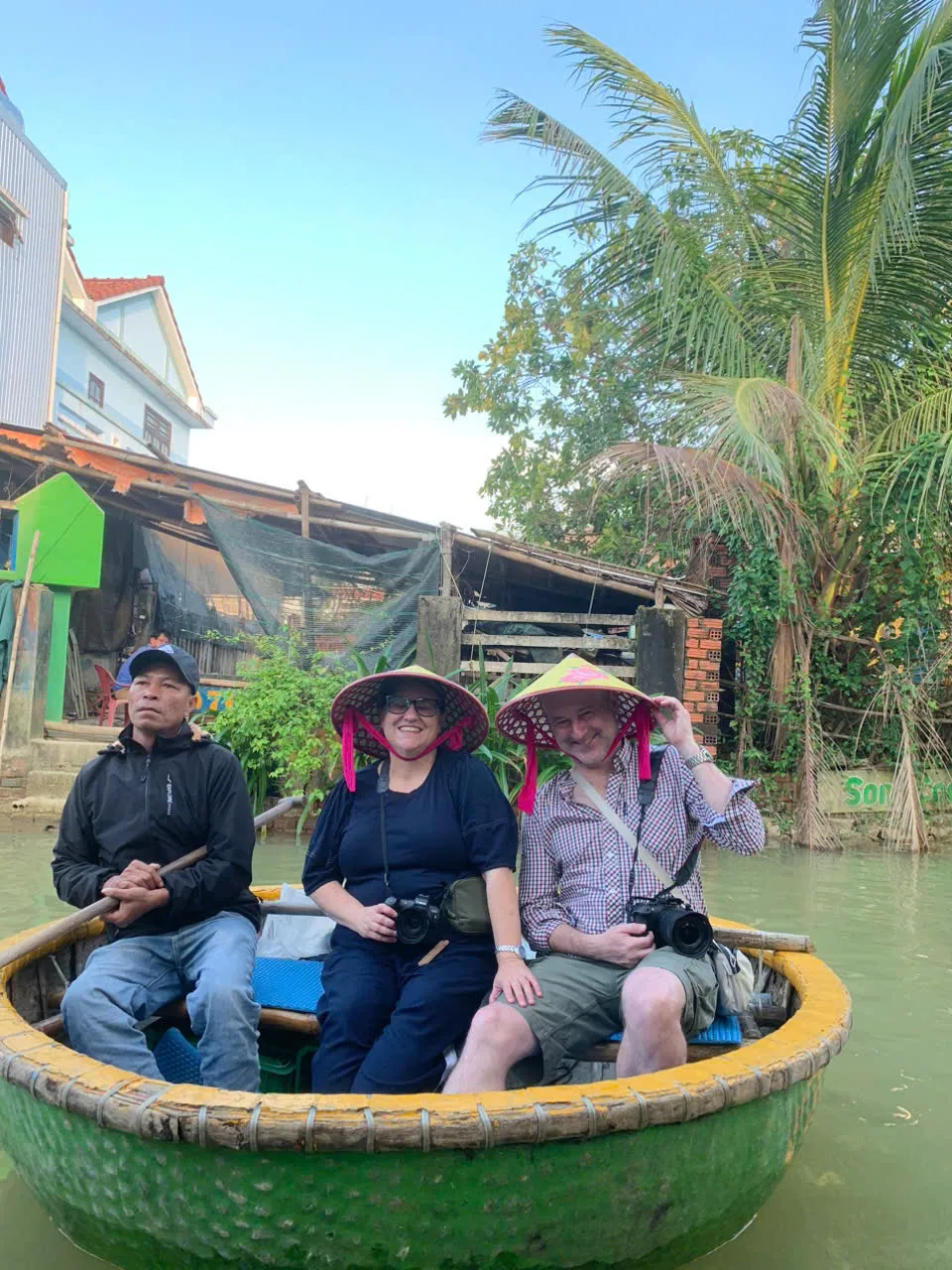 Guests floating in a bamboo basket boat in the Hoi An Coconut Forest